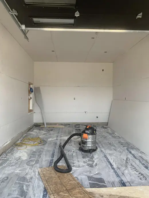 Residential garage, boarded and swept out